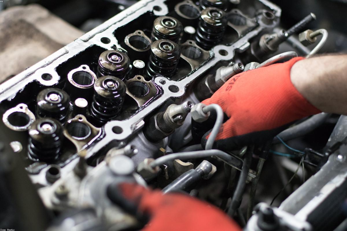 Mechanic performing service work on a customer vehicle at Car Vest Own